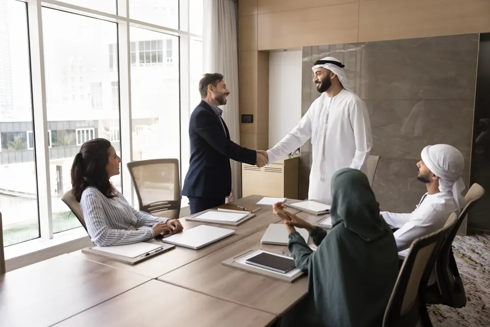 Business advisors greeting a client in a meeting